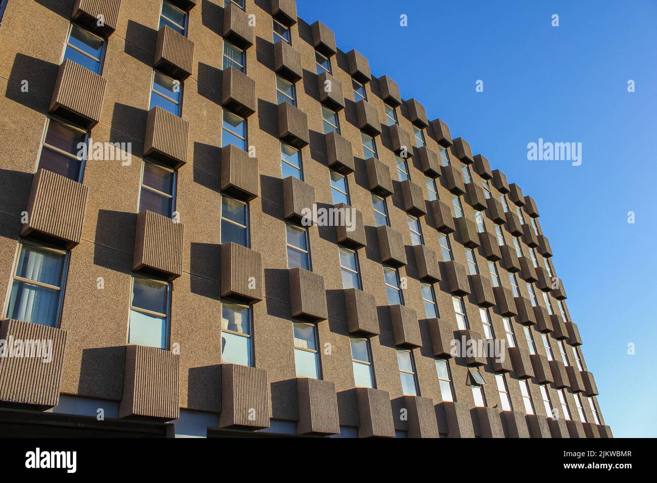 An office building exterior against a blue sky Stock Photo - Alamy