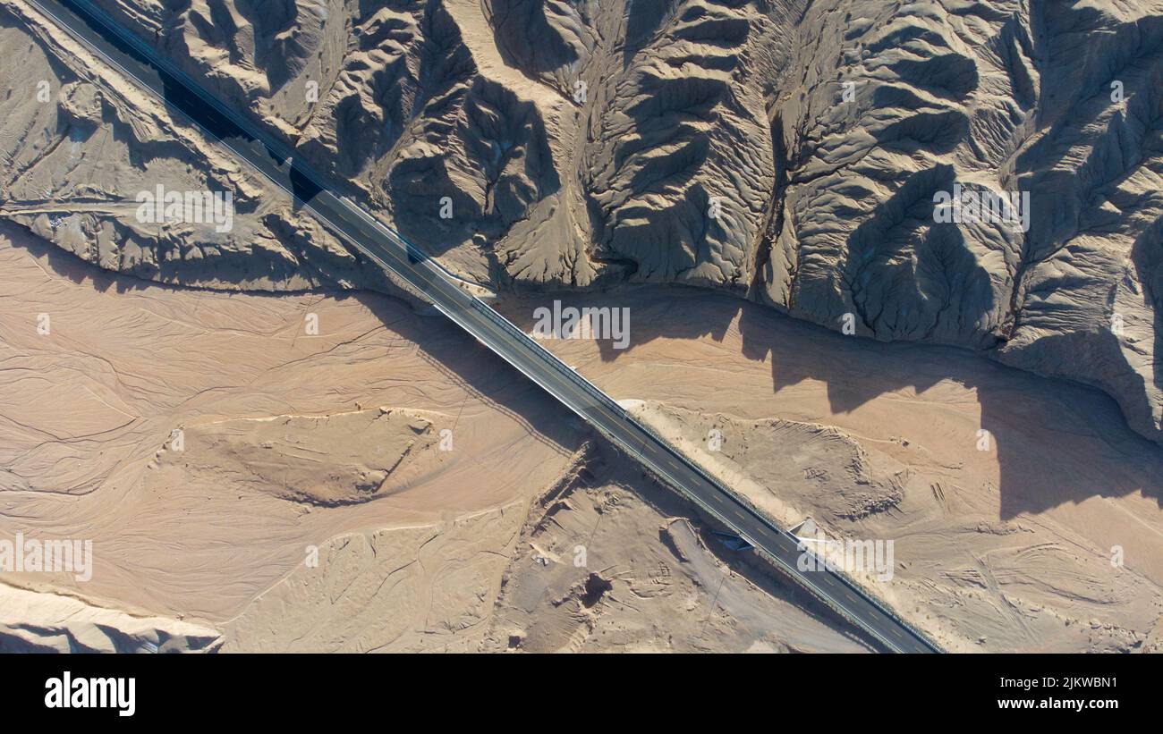 An aerial view of the road on wind erosion terrain in Qinghai Stock ...