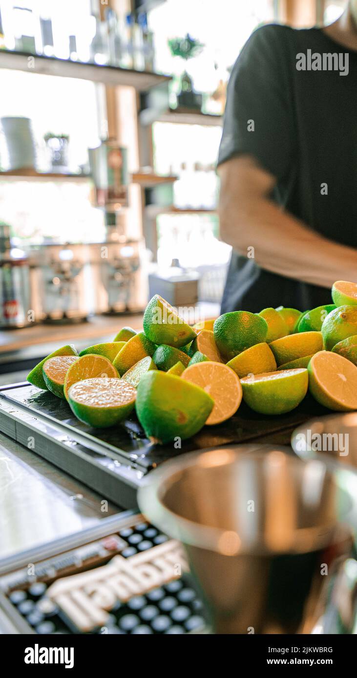 Cut limes on a board in a bar kitchen Stock Photo Alamy
