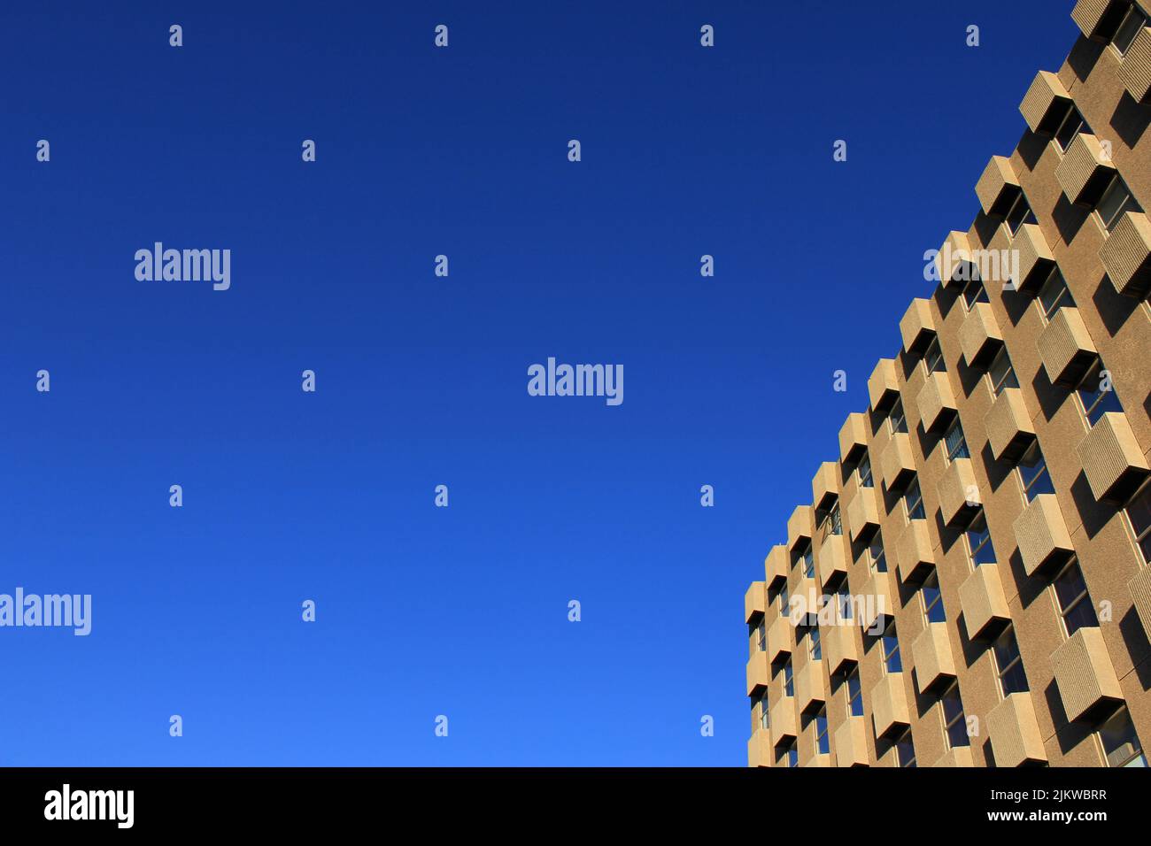 An office building exterior against a blue sky Stock Photo - Alamy