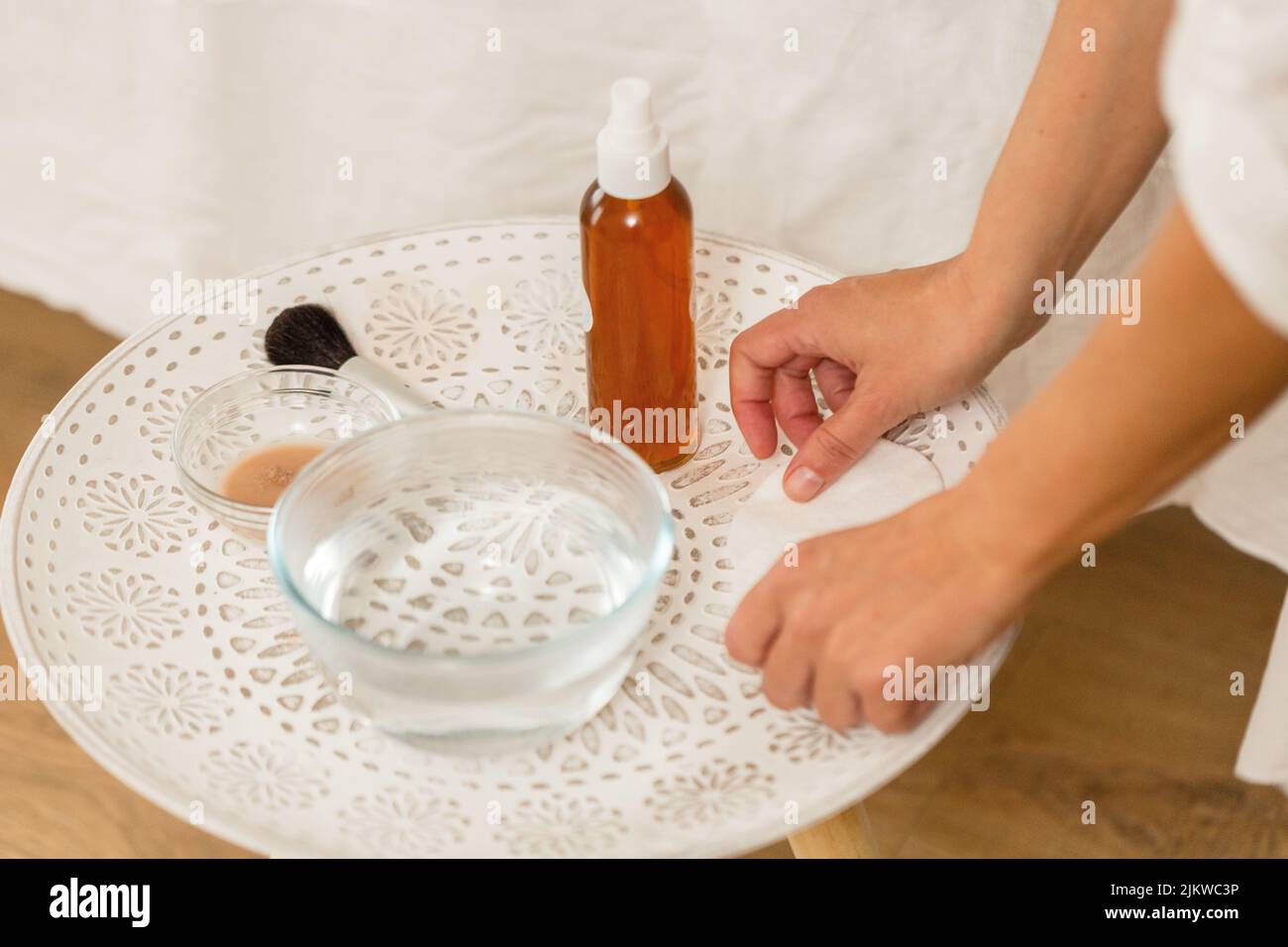 A person's hands on the table with essential oils and tolls for massage Stock Photo