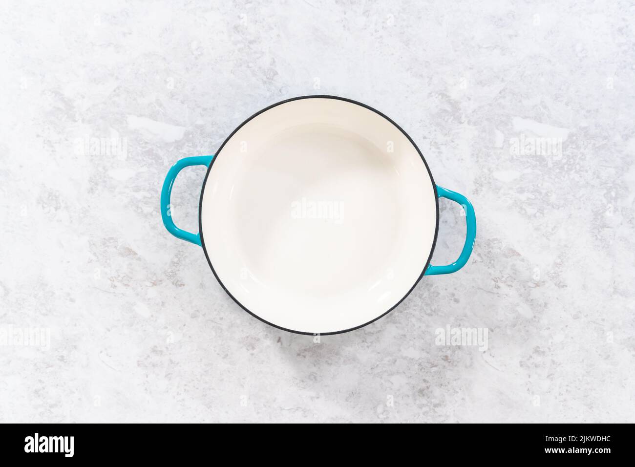 Cleaning cast iron blue enameled braiser Stock Photo Alamy
