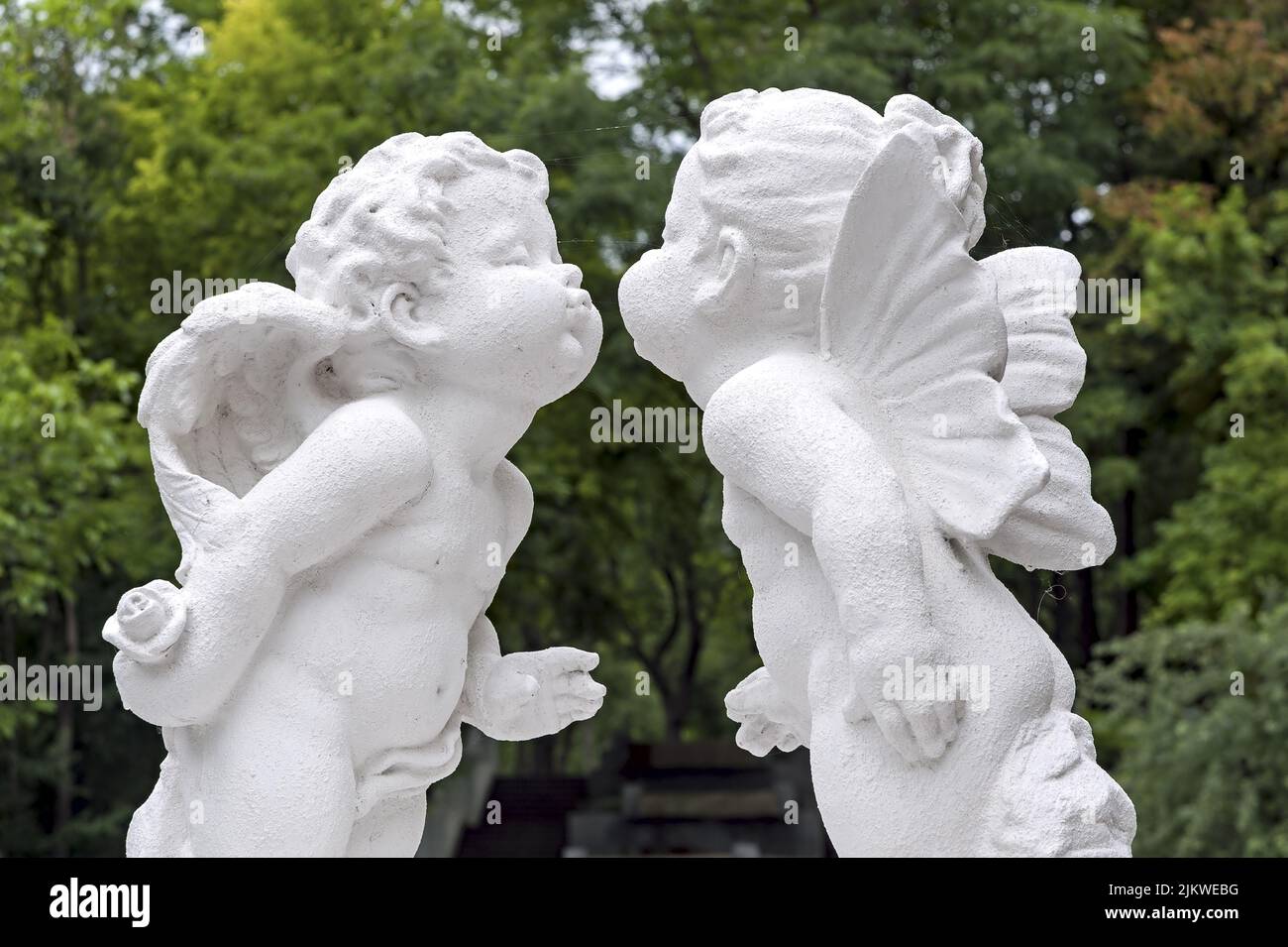 Sculpture of kissing angels in park Stock Photo Alamy