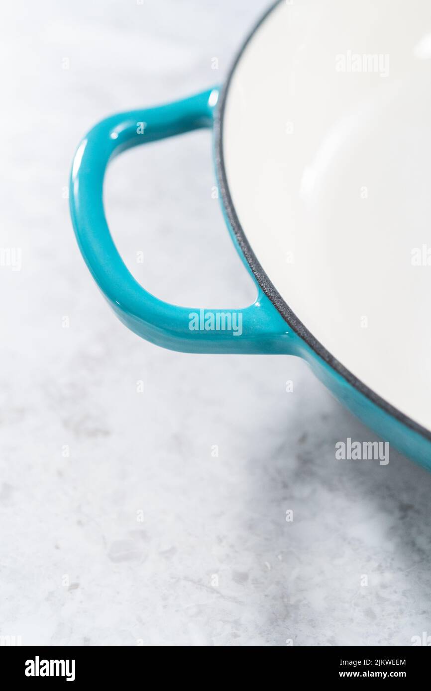 Cleaning cast iron blue enameled braiser Stock Photo Alamy