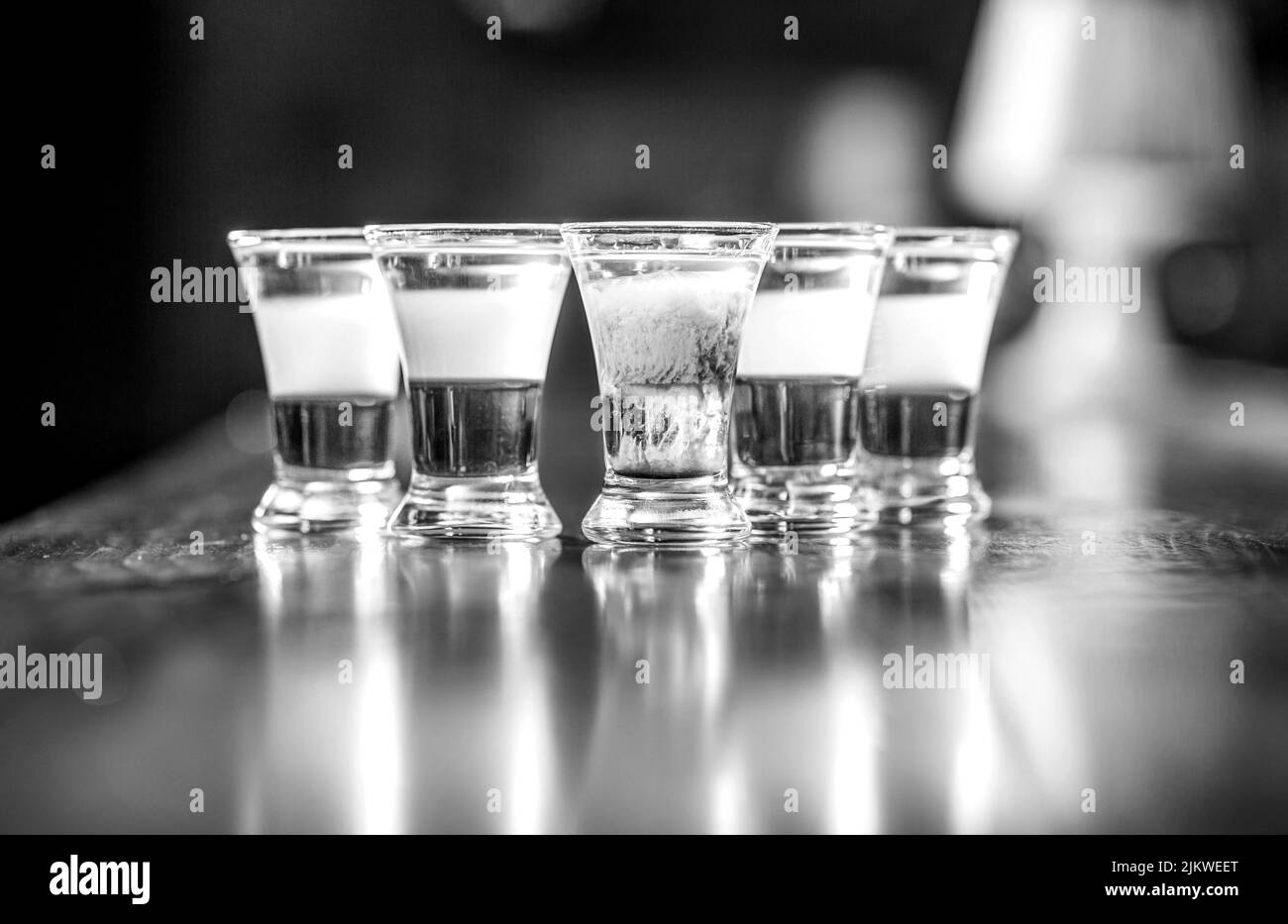Alcoholic drink in different colors. Shots at the bar table. Alcoholic drinks in shot glasses. Tequila shots, vodka, whisky. Set of alcoholic Stock Photo