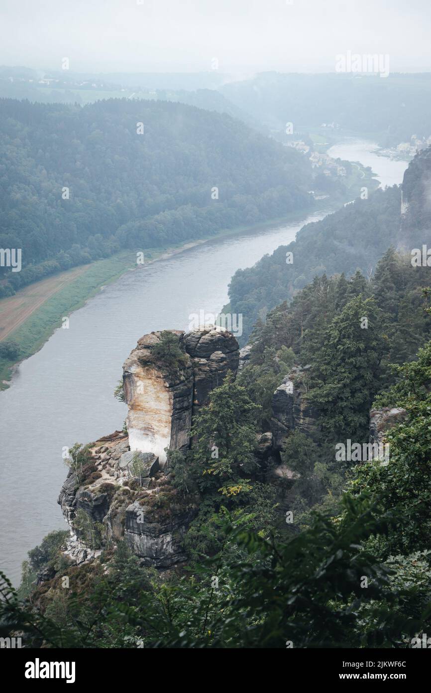 Photo at the Saxon Switzerland national park on a misty day with incredible rock formations shooting up from the ground Stock Photo
