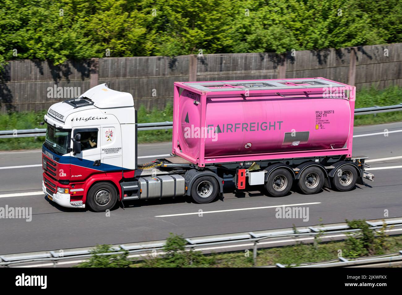 Hoogendoorn Scania truck with Fairfreight tank container on motorway Stock Photo