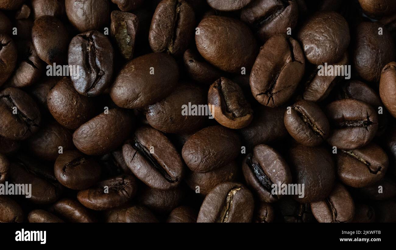 roasted and brown coffee beans background Stock Photo - Alamy