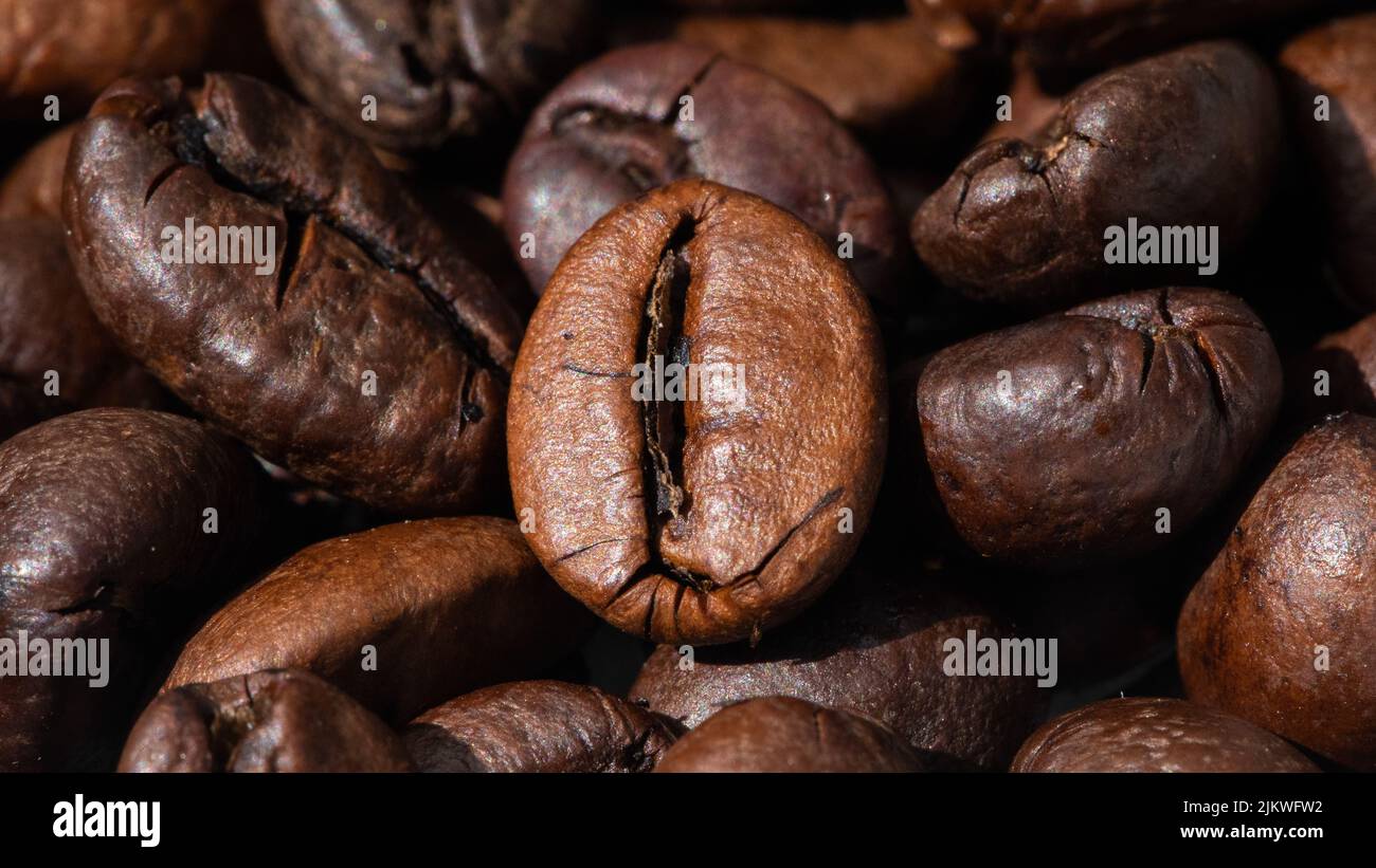 roasted and brown coffee beans background Stock Photo - Alamy