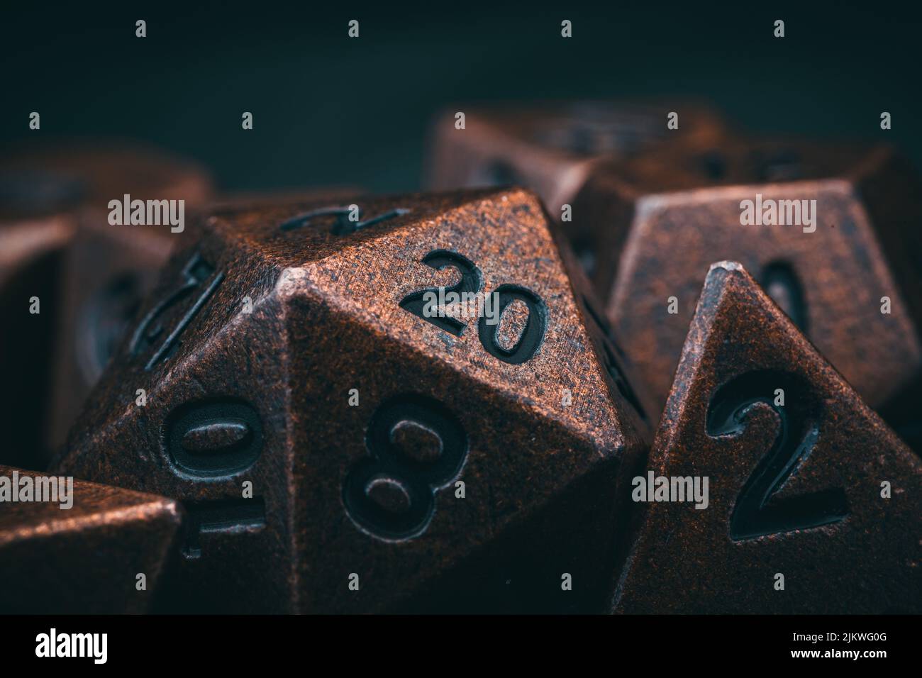 A closeup of brown metal dungeons and dragons dice Stock Photo