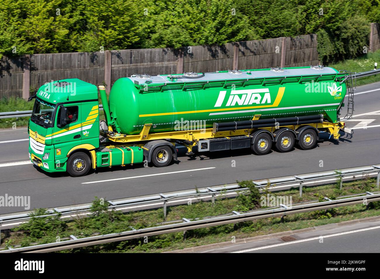 Intra Mercedes-Benz Actros truck with silo trailer on motorway Stock Photo