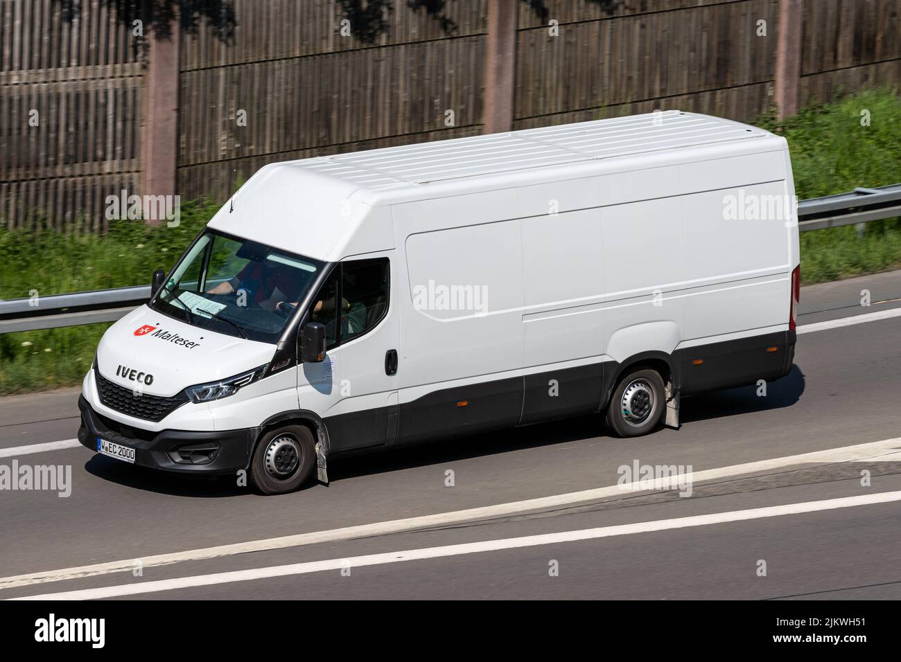 Malteser Iveco Daily van on motorway Stock Photo