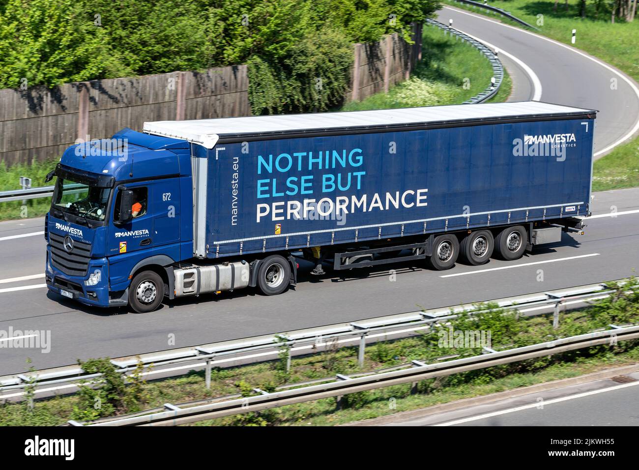 Manvesta Mercedes-Benz Actros truck with curtainside trailer on motorway Stock Photo