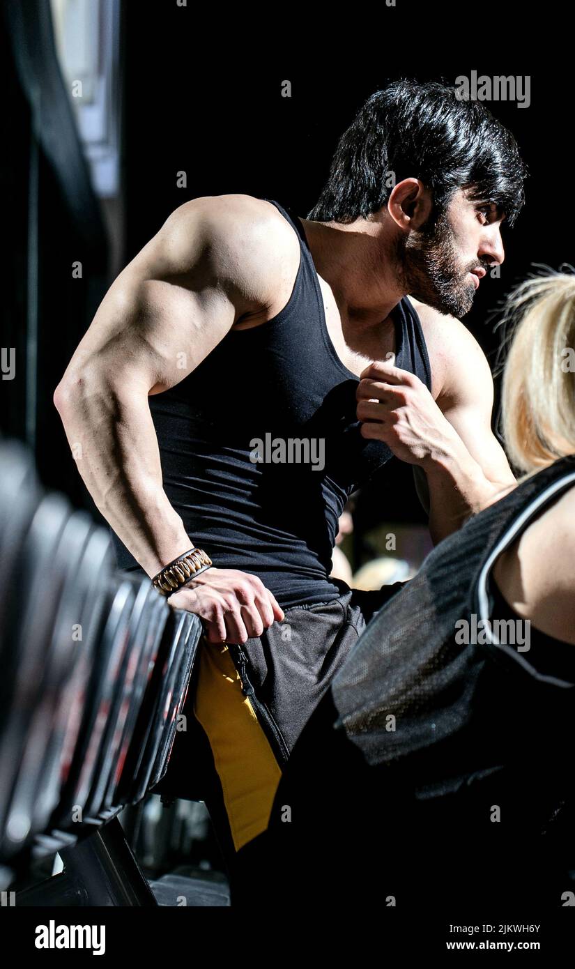 A vertical shot of a fit athletic muscular Caucasian man working out at the gym Stock Photo