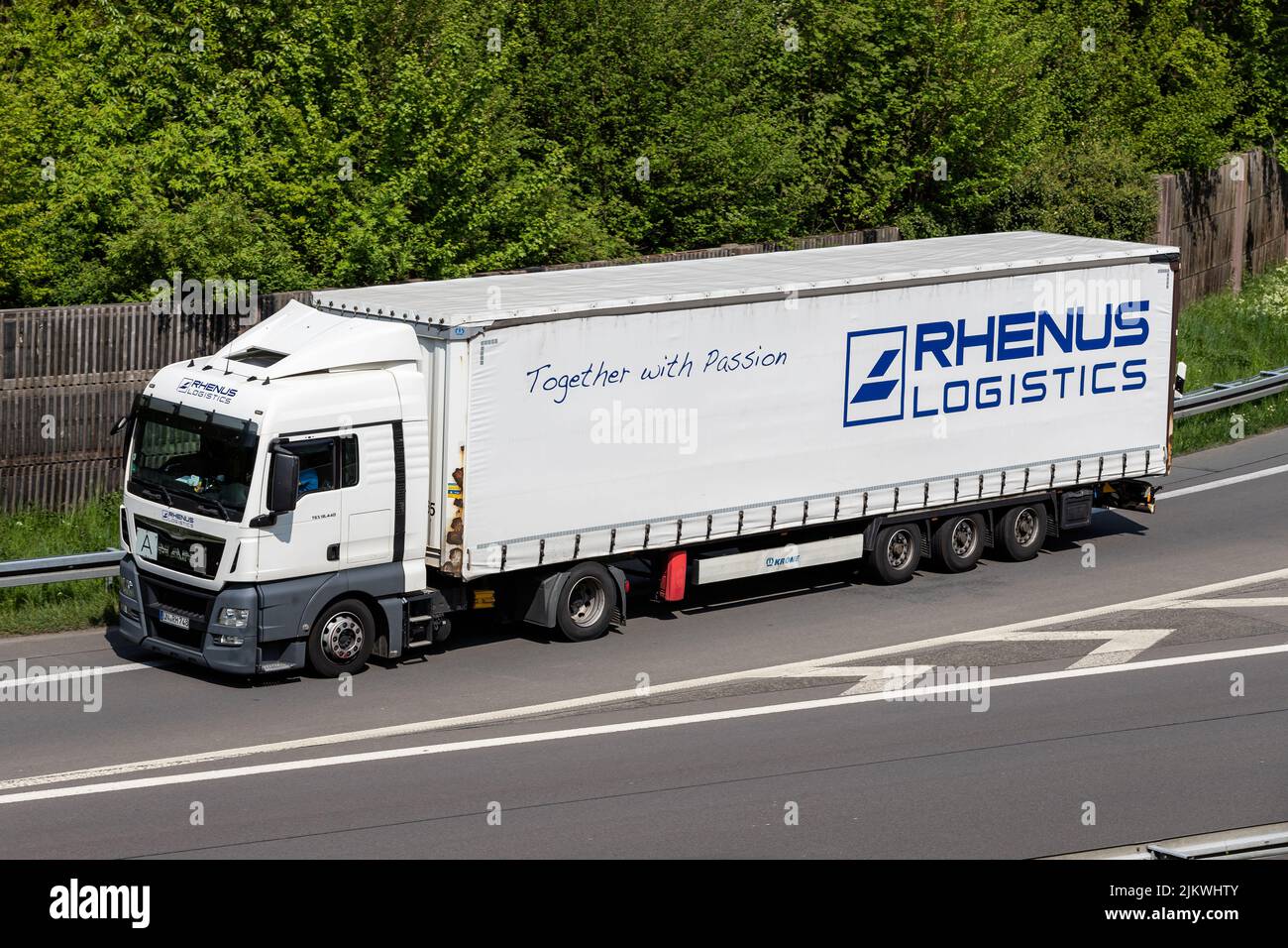 Rhenus Logistics MAN TGX truck with curtainside trailer on motorway Stock Photo