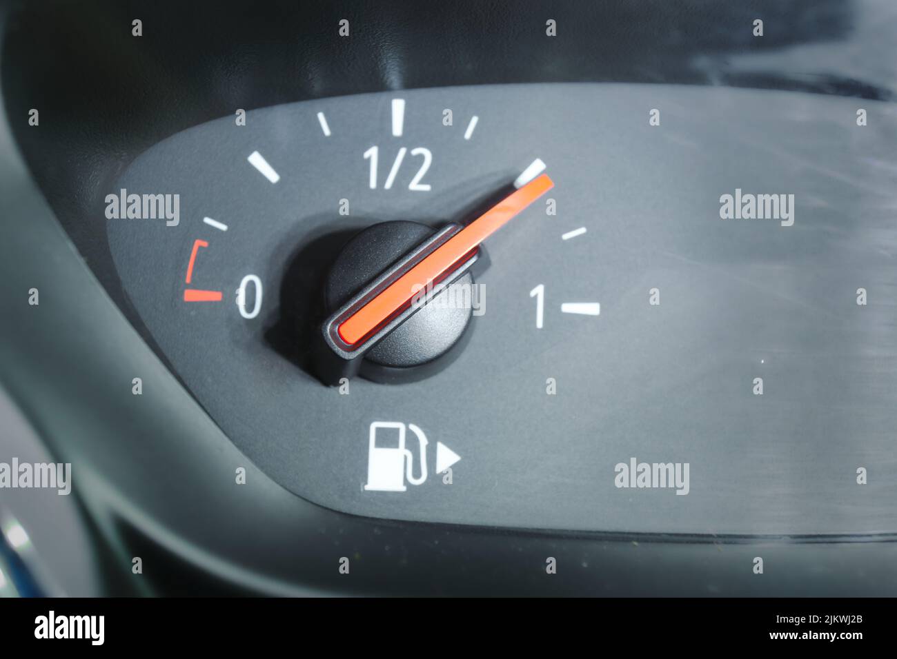 Closeup of a fuel gauge showing a threequarters full fuel tank in a