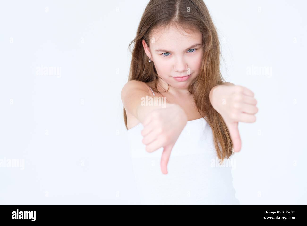 emotion disapproving displeased child thumb down Stock Photo