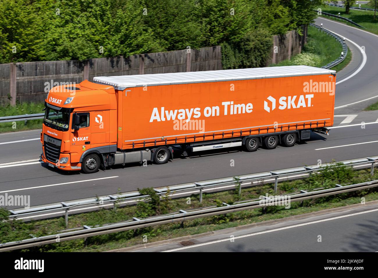 SKAT DAF XF truck with curtainside trailer on motorway Stock Photo