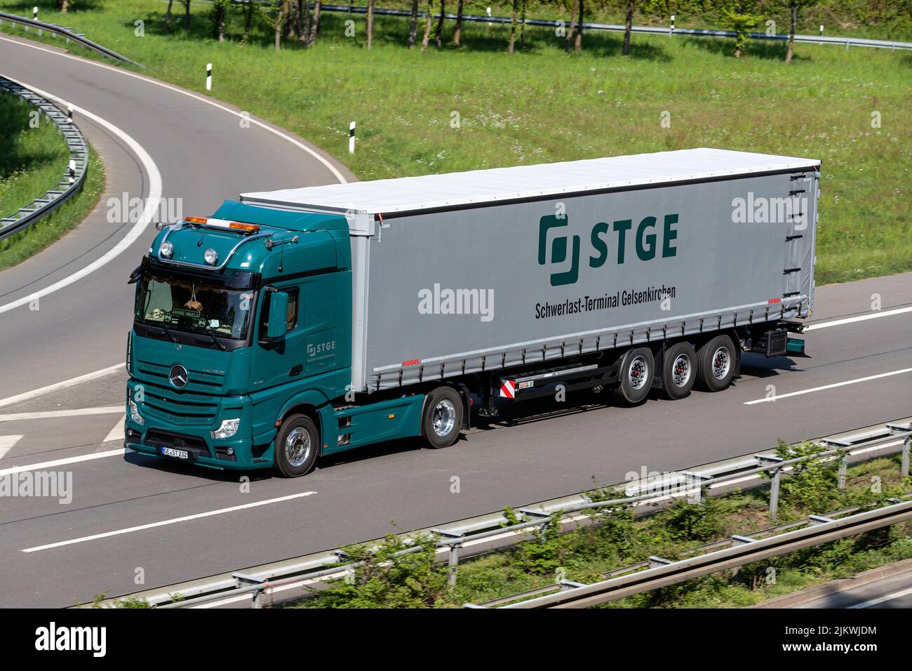 STGE Mercedes-Benz Actros truck with curtainside trailer on motorway Stock Photo