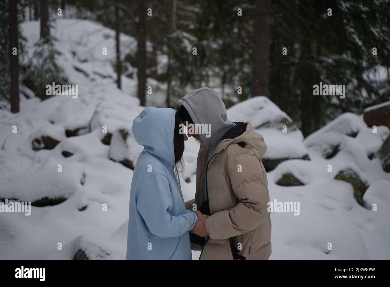 A beautiful couple in a forest in winter in Ukraine Stock Photo