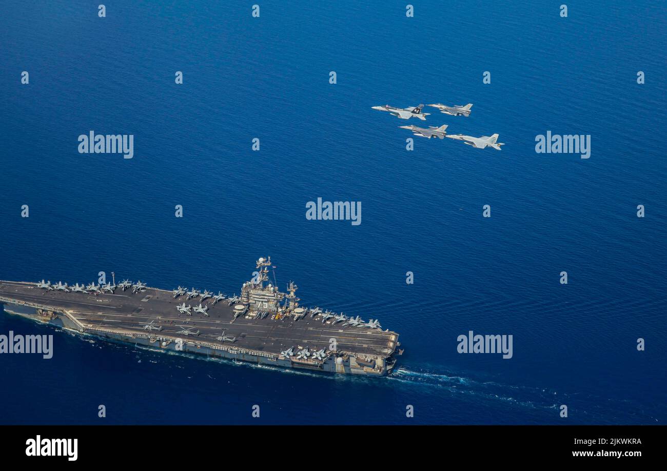 At Sea. 29th July, 2022. F/A-18E Super Hornets attached to Carrier Air Wing 1 (CVW-1) and Belgian air force F-16s fly in formation over the Nimitz-class aircraft carrier USS Harry S. Truman (CVN 75), July 25, 2022. The Harry S. Truman Carrier Strike Group is on a scheduled deployment in the U.S. Naval Forces Europe area of operations, employed by U.S. 6th Fleet to defend U.S., allied and partner interests. Credit: U.S. Navy/ZUMA Press Wire Service/ZUMAPRESS.com/Alamy Live News Stock Photo