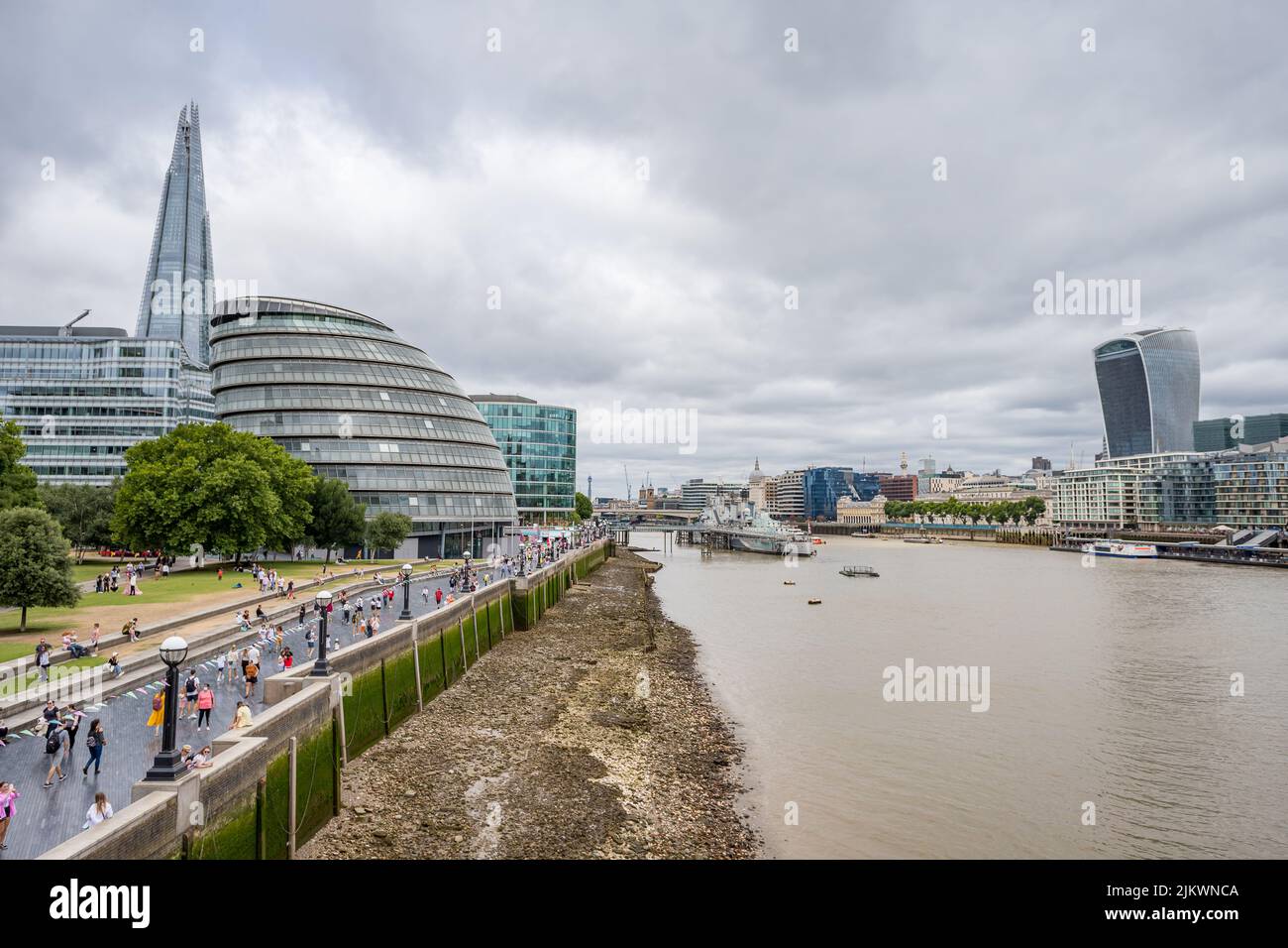 The Pool of London are of the River Thames in London surrounded by iconic landmarks in August 2022 including The Shard, The Scoop, HMS Belfast and the Stock Photo