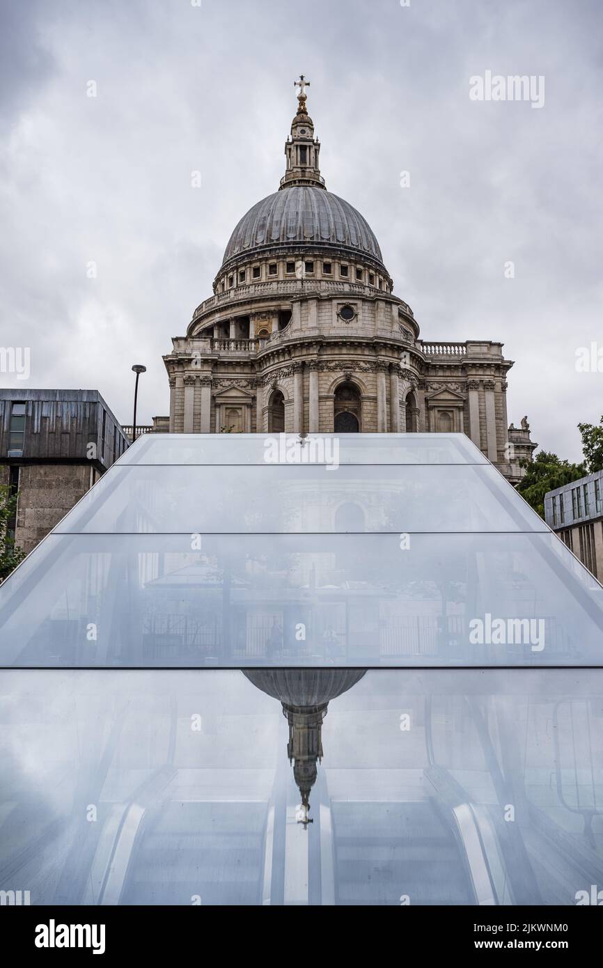 Reflection of the iconic dome and spire on top of St Pauls Cathedral in London reflecting on a glass roof above an escalator in London seen in July 20 Stock Photo