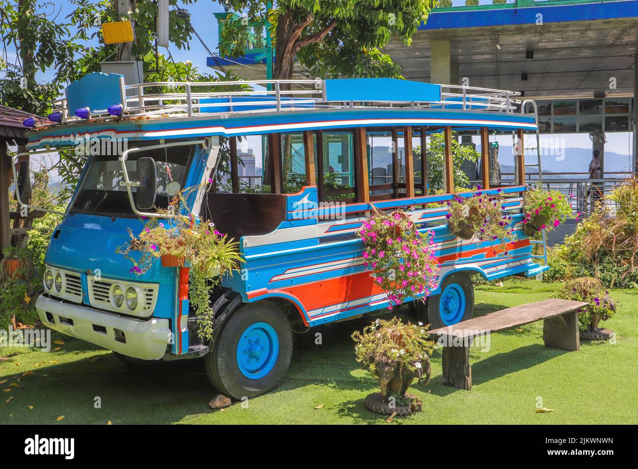 A colorful bus on the beach decorated with flowers Stock Photo