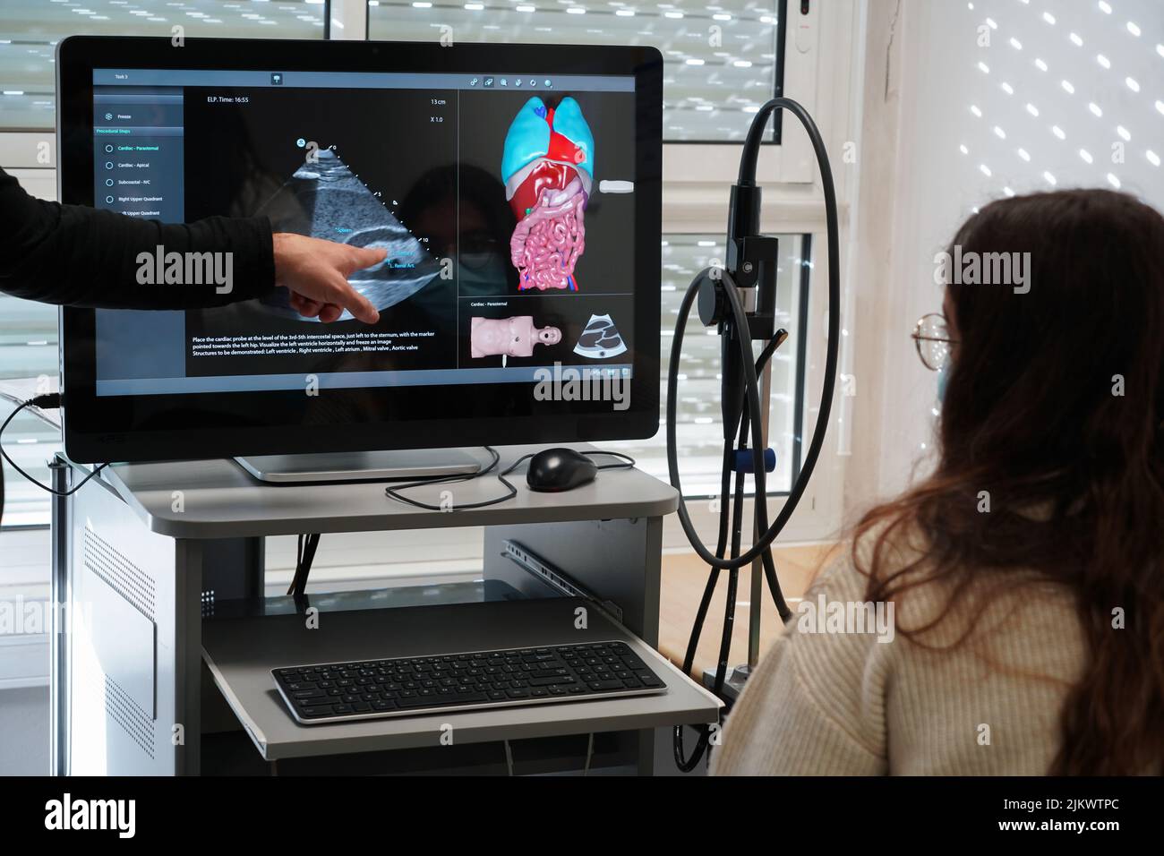 Students and their teacher during an echography simulation workshop on a robot mannequin. Stock Photo