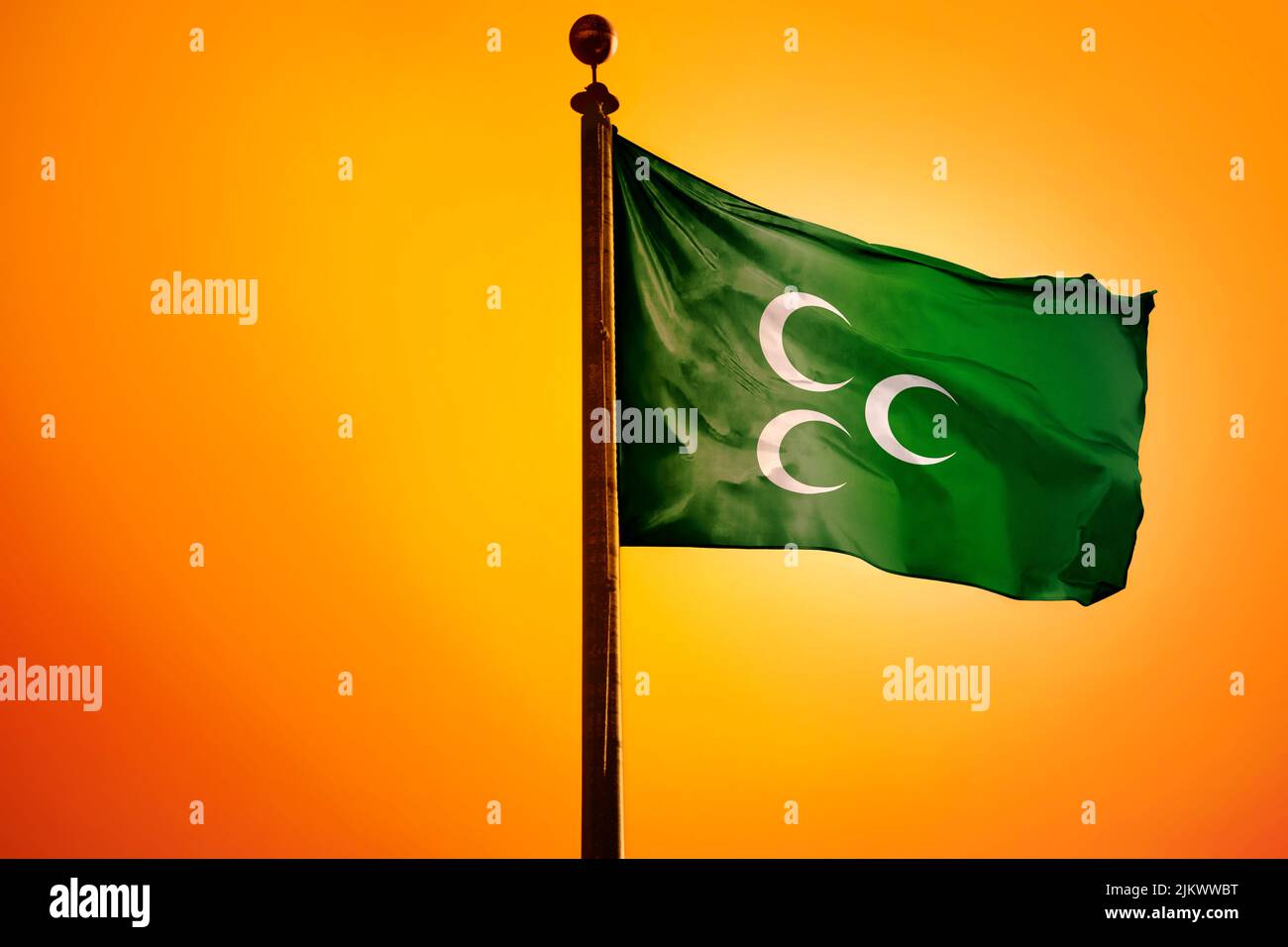A digital illustration of the Rumelian flag of the Ottoman Empire waving against a bright yellow sky Stock Photo
