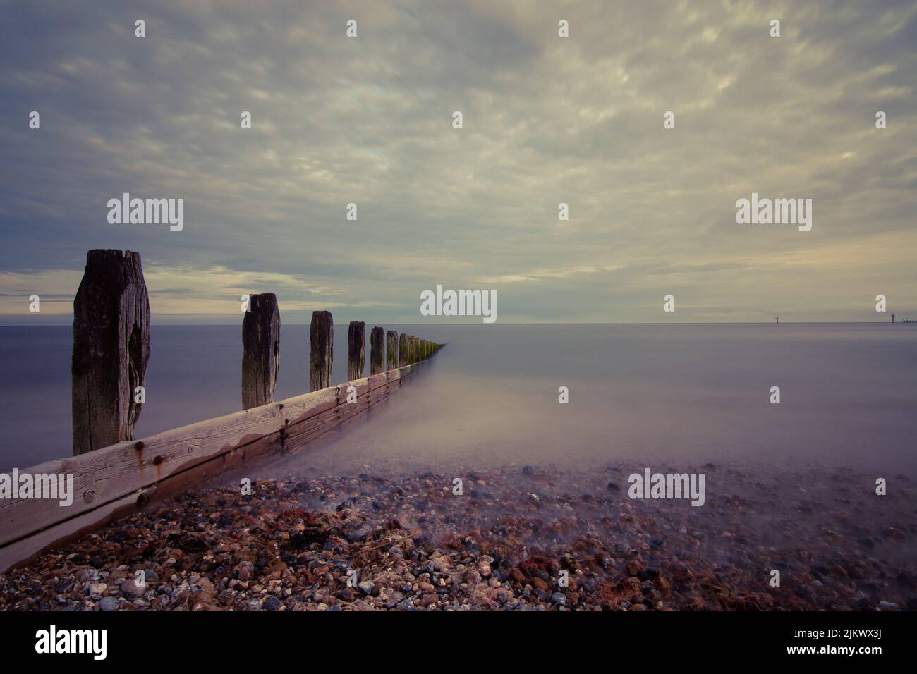 A scenic view of wave breakers on the sea with long exposure in Littlehampton Stock Photo