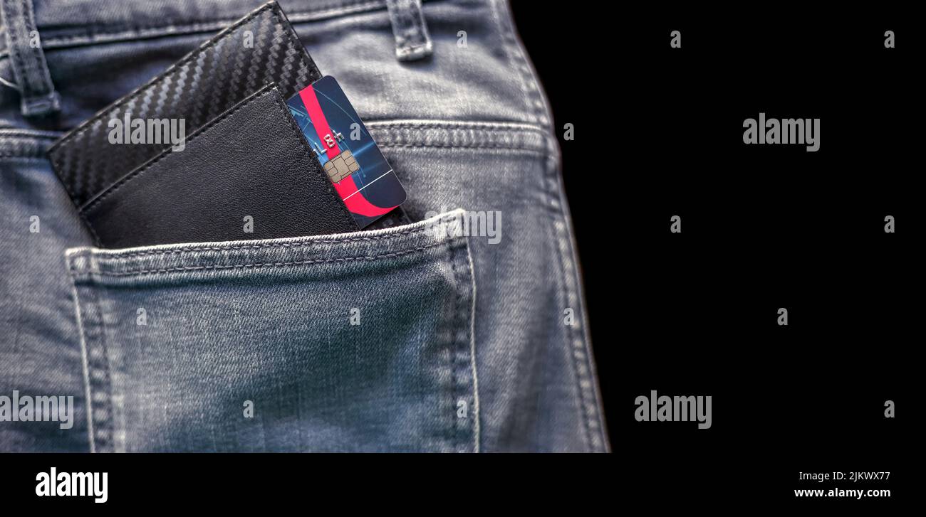 Credit card in the black wallet sticking out of the back pocket of the pants Stock Photo