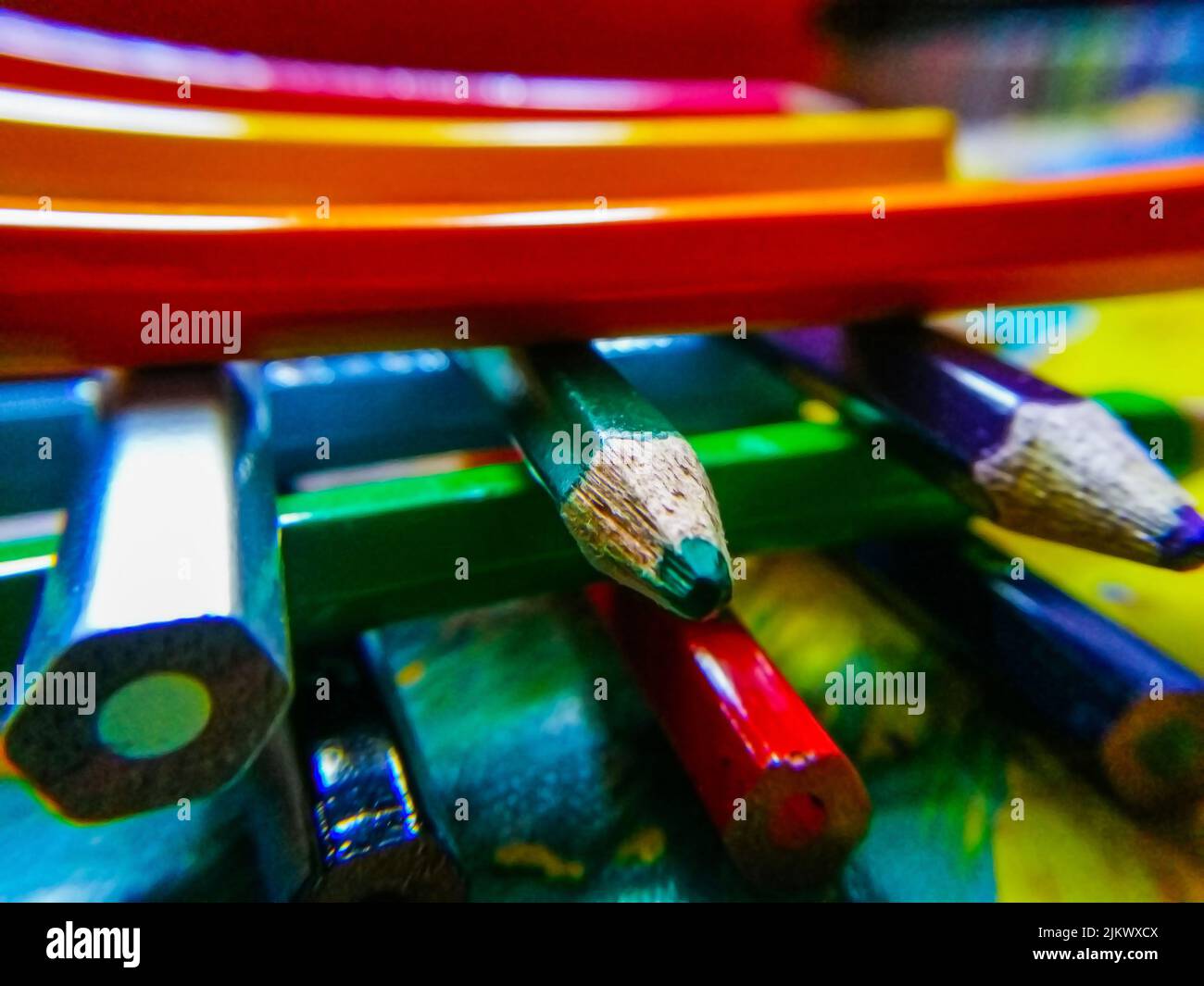 Stock photo of color pencil crayons arranged one over the other on