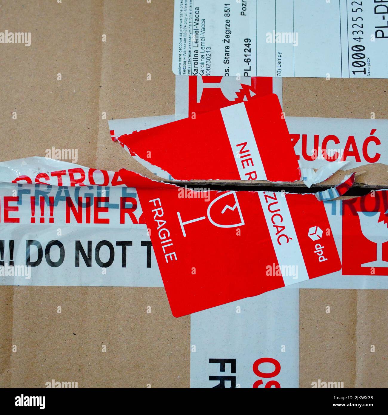 A delivery box with tape and sticker warning for fragile items Stock Photo