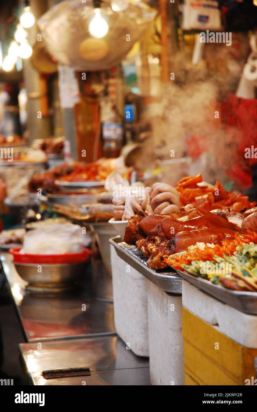 Night food market in Seoul South Korean with food and steam under lights Stock Photo