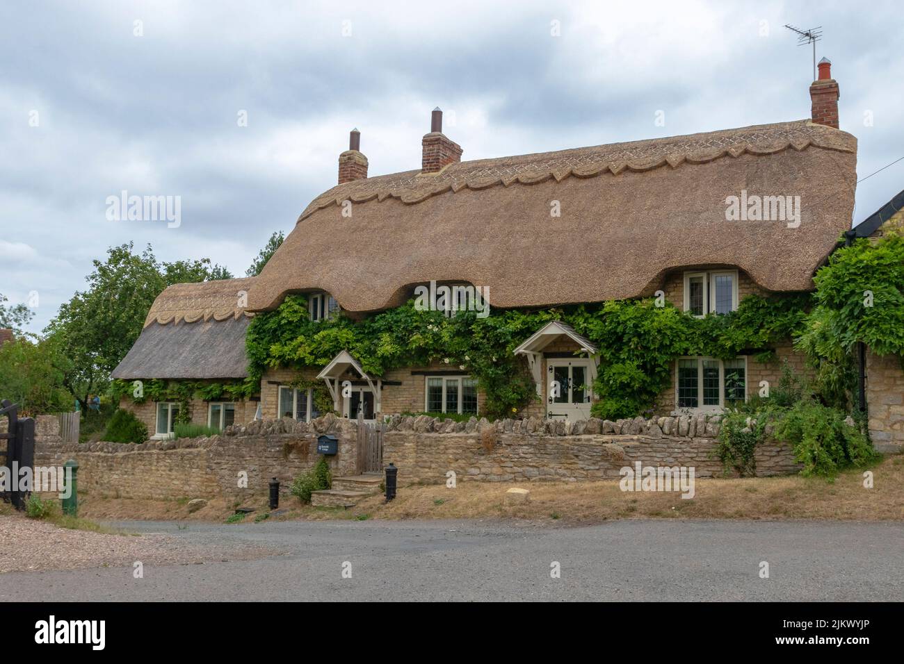 Ravenstone, Buckinghamshire, England, July 30, 2022:A traditional Thatched cottage in the village of Ravenstone North Buckinghamshire Stock Photo
