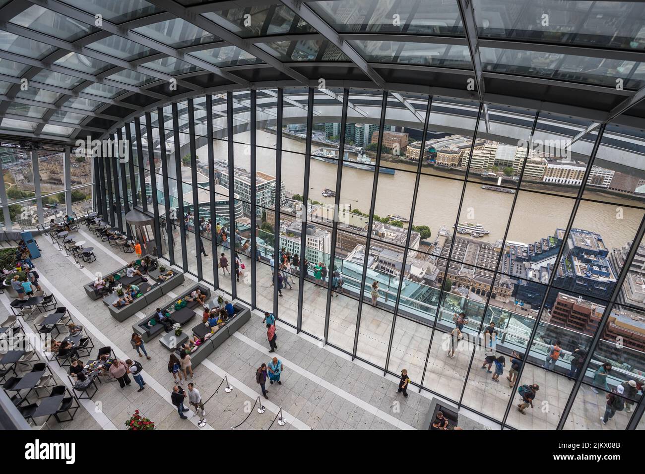 Looking down on tourists on the outside roof terrace of the Sky Garden on top of the Walkie Talkie Building in London seen in August 2022. Stock Photo