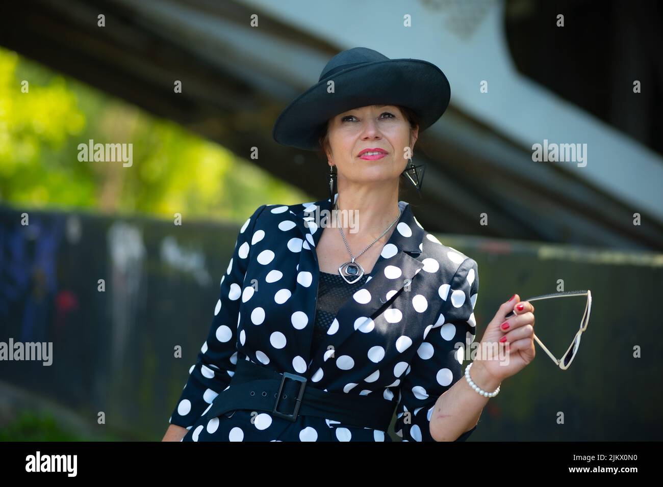 Elegant woman, pretty women, woman in a hat in sunglasses with a red