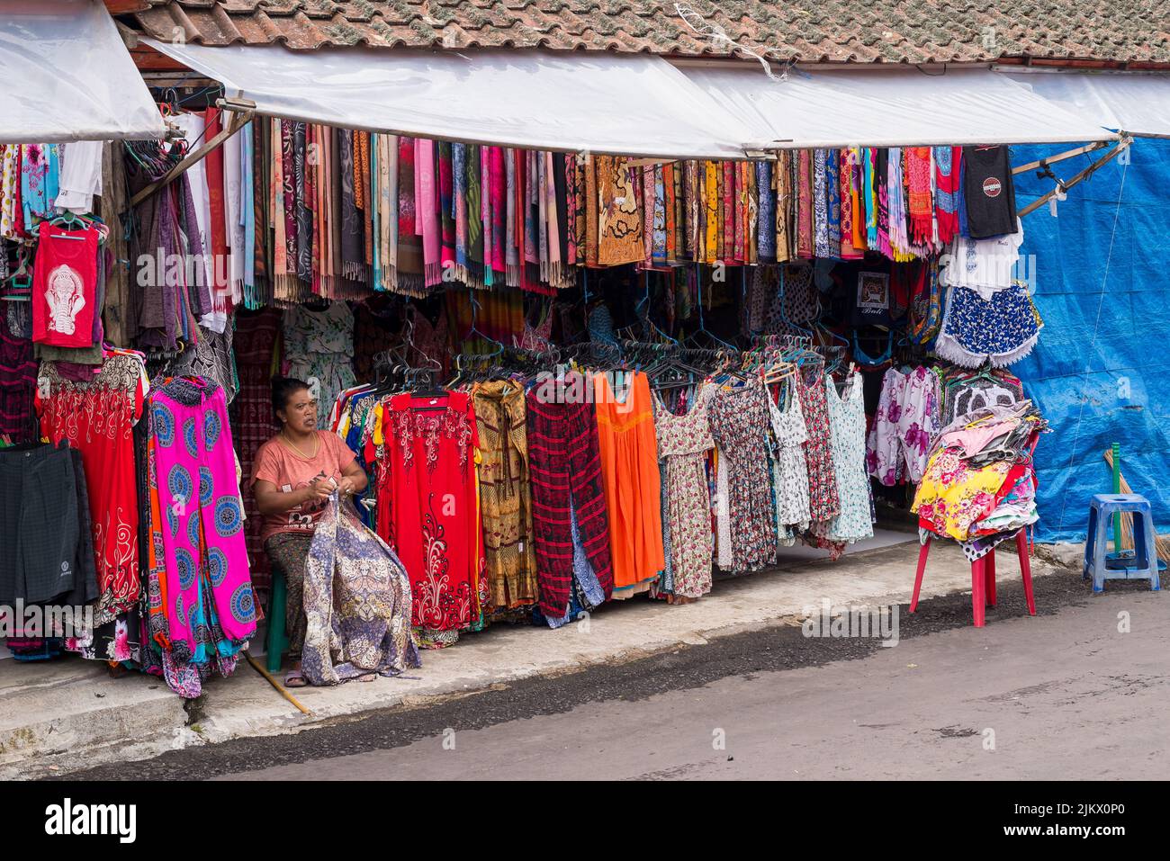 A Balinese woman selling colorful clothing at markets in Bali