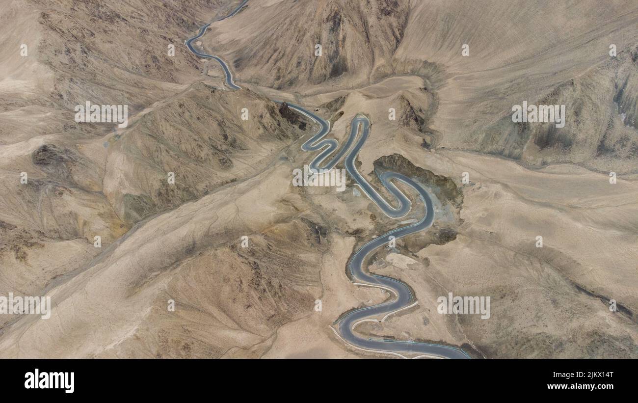An aerial view of a winding race road in the hills of a desert Stock ...