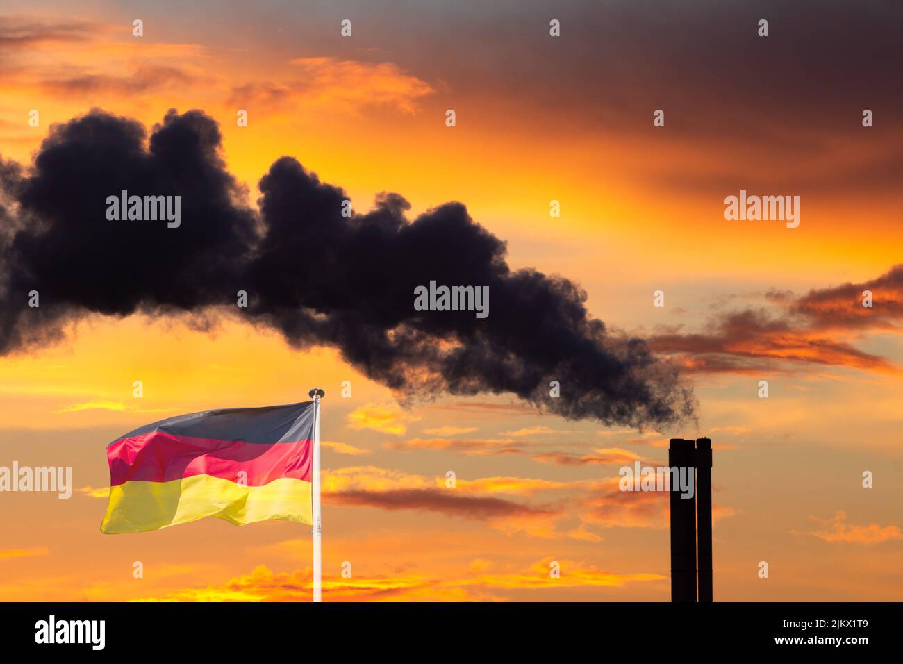 Flag of Germany and factory chimney belching black smoke. Fossil fuels, coal, energy, gas, crisis, prices, Russia, Russian gas... concept Stock Photo