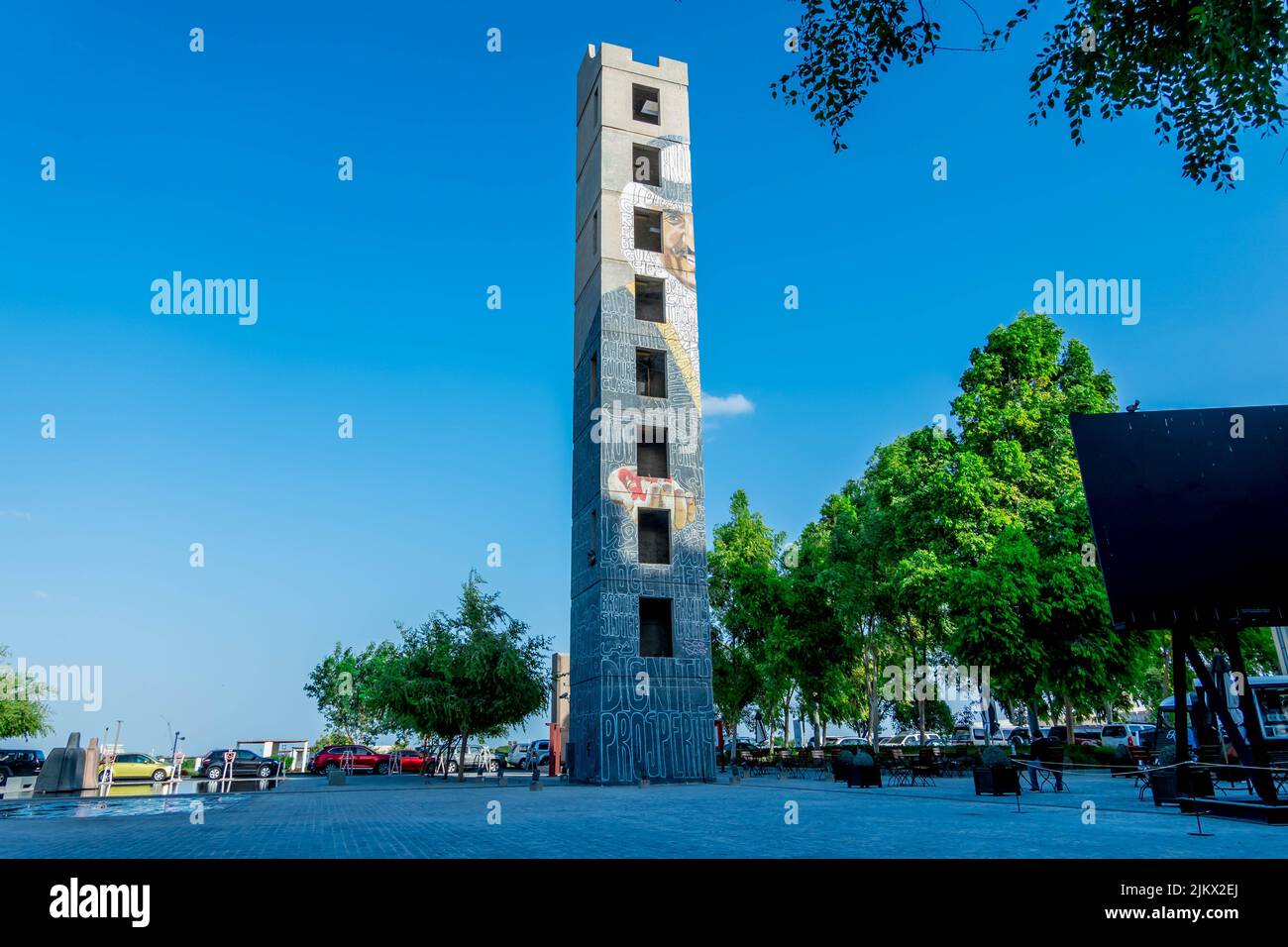 A bottom shot of a tower with a human face painting in Qatar Stock