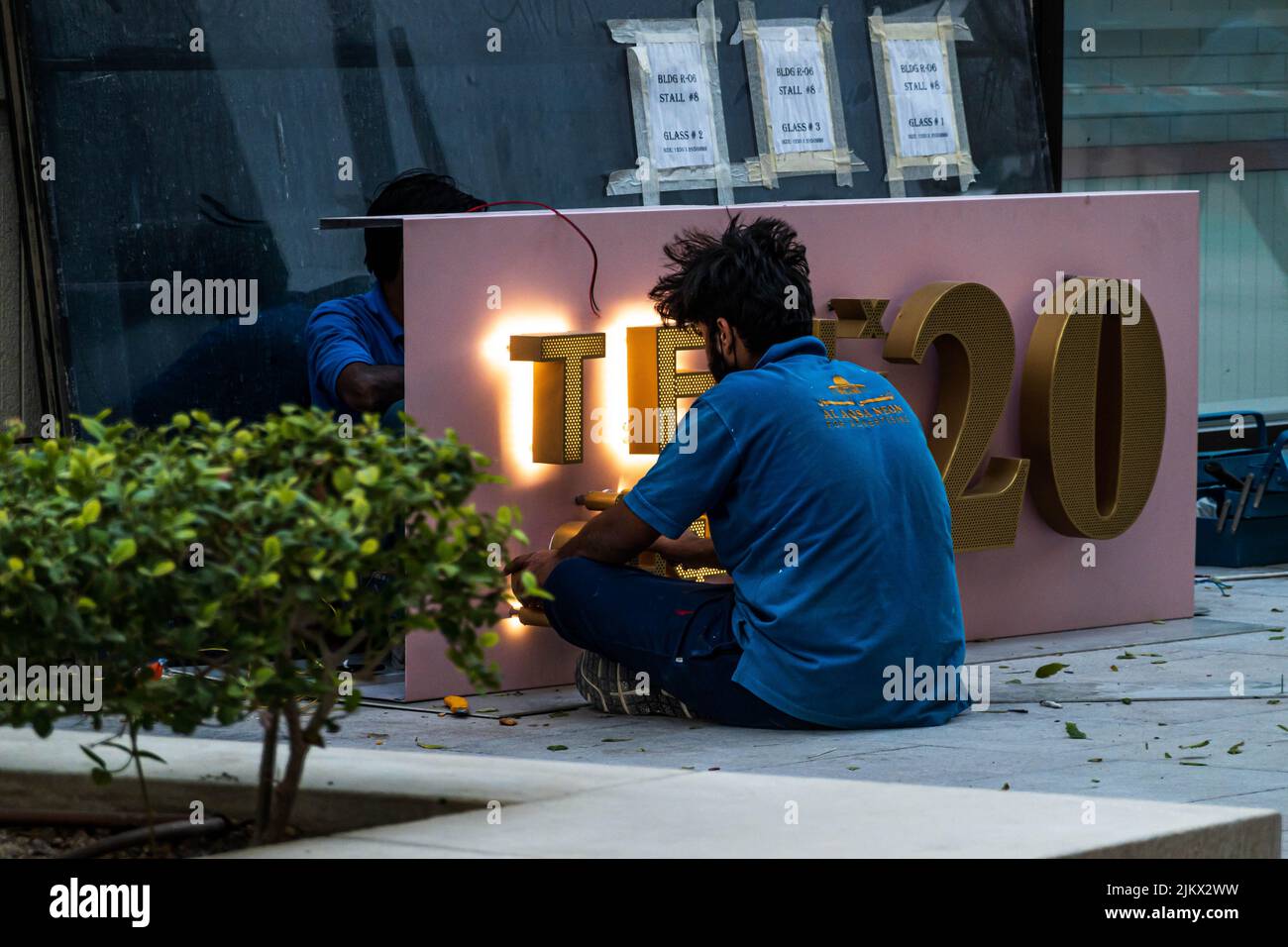 A man sitting alone on a street in Msheireb Downtown Doha, Qatar Stock Photo
