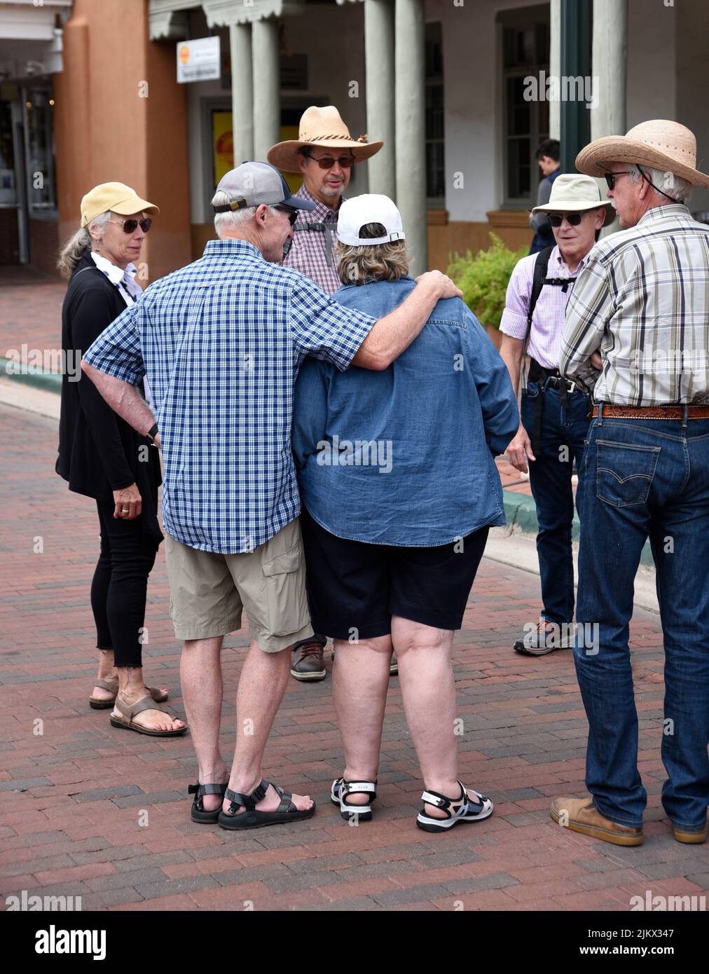 A tour guide leads a group of visitors around the historic district in Santa Fe, New Mexico. Stock Photo