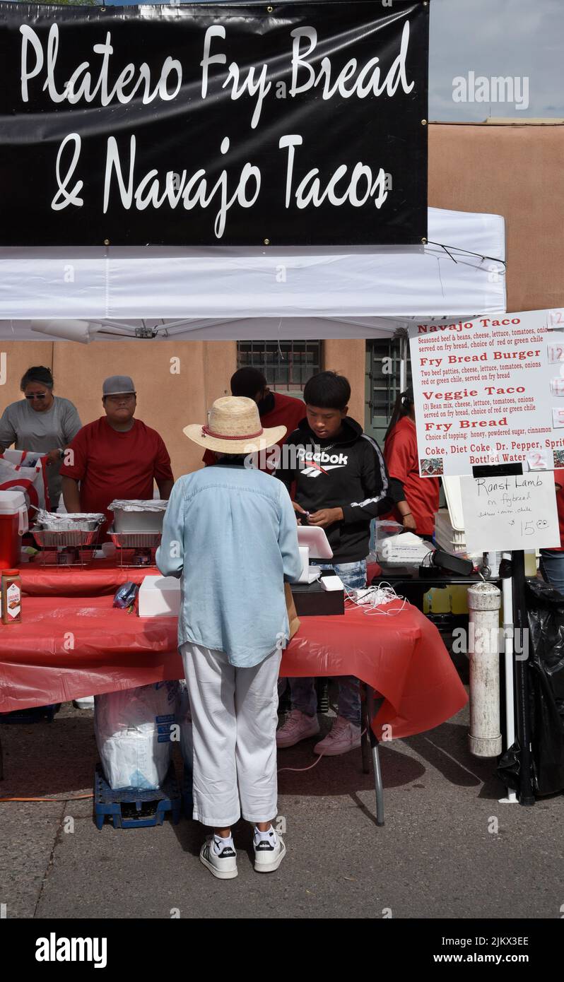Customers purchase lunch at a Native-American food vendor at an outdoor festival in Santa Fe, New Mexico. Stock Photo
