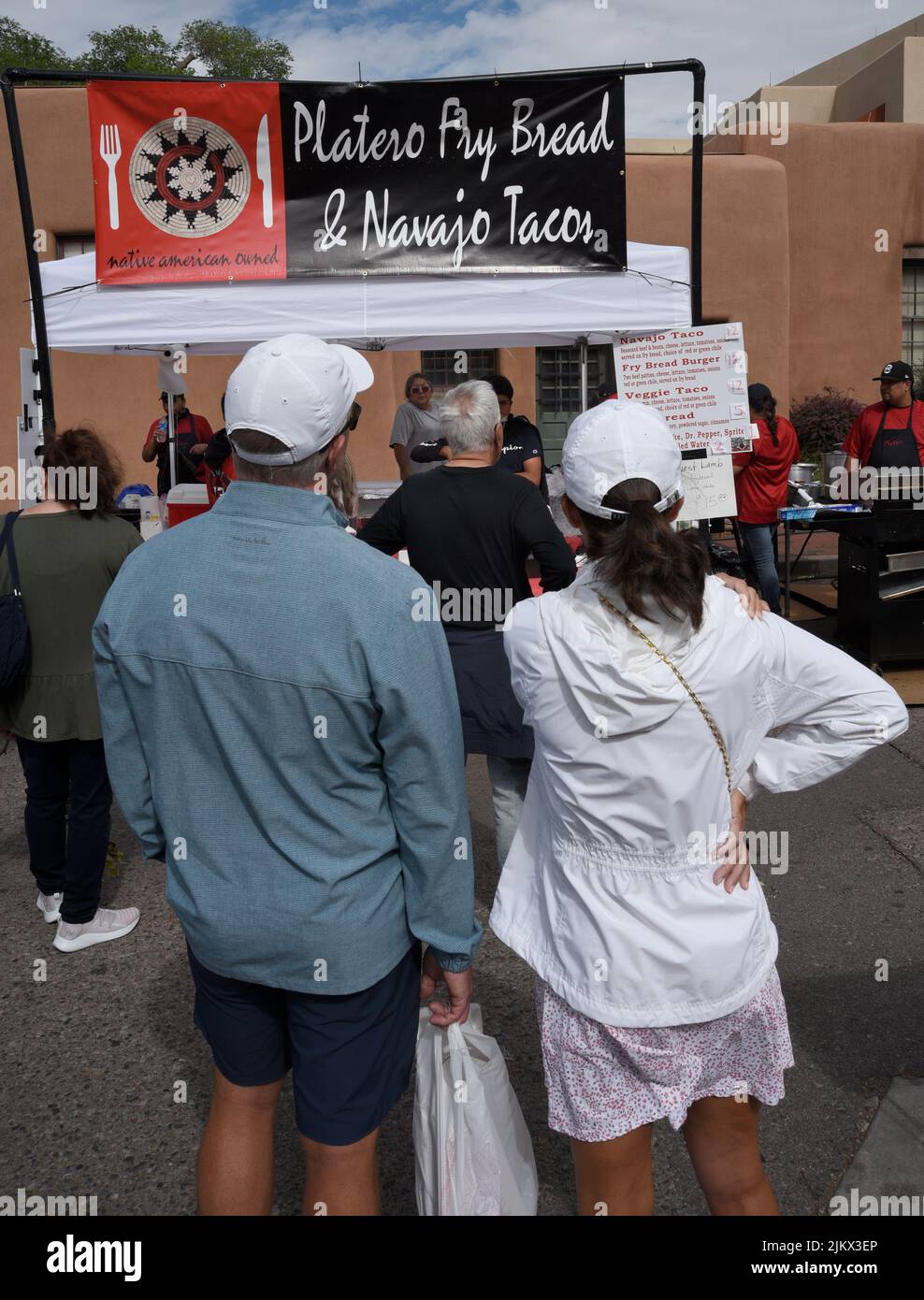 Customers purchase lunch at a Native-American food vendor at an outdoor festival in Santa Fe, New Mexico. Stock Photo