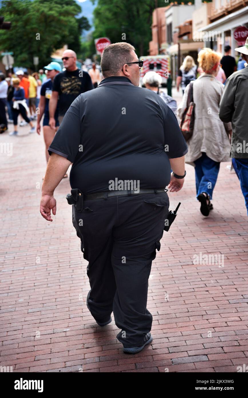 A security officer patrols the streets at an outdoor arts festival in Santa Fe, New Mexico. Stock Photo