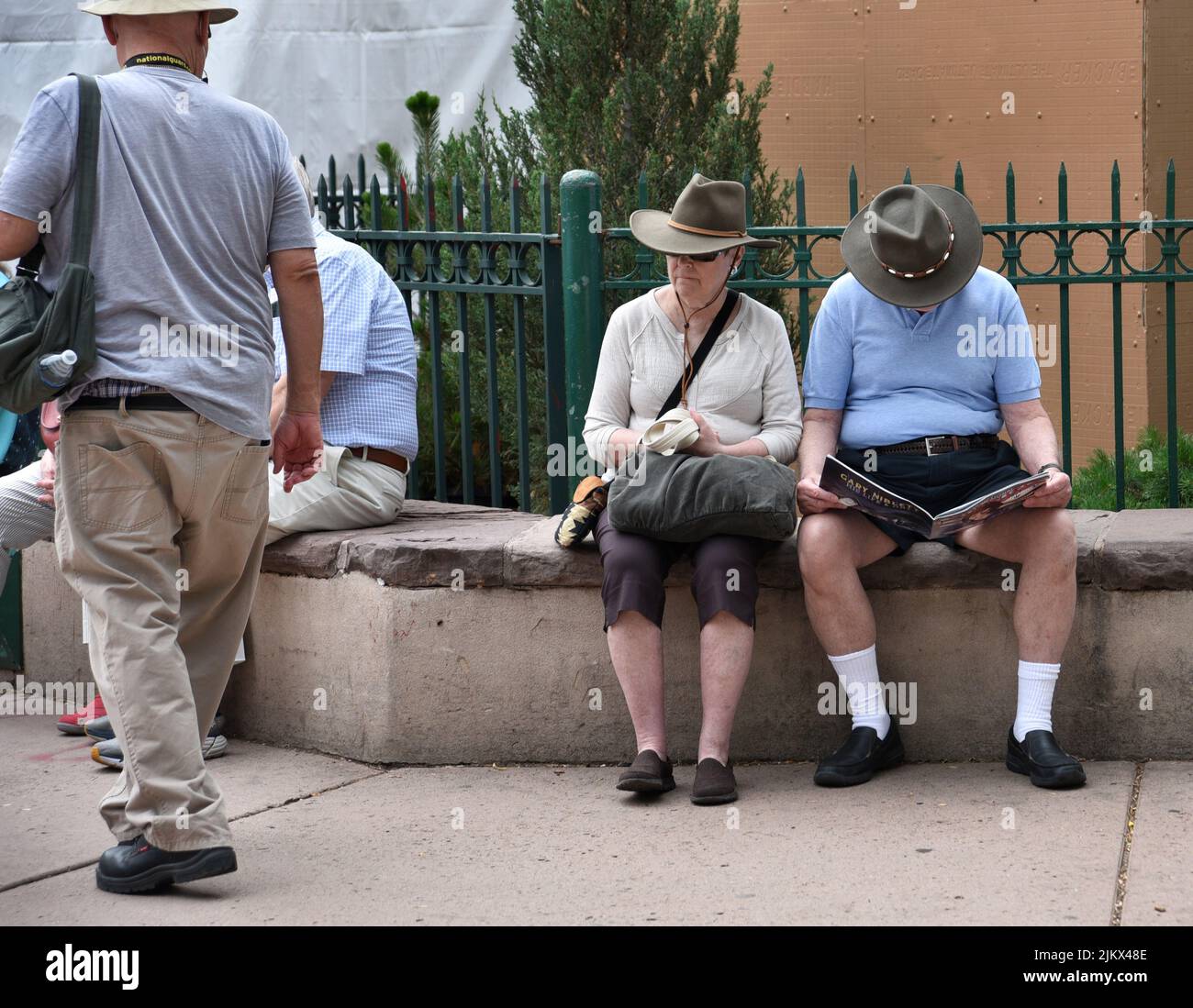 Tourists pause to rest in the historic Plaza in Santa Fe, New Mexico. Stock Photo