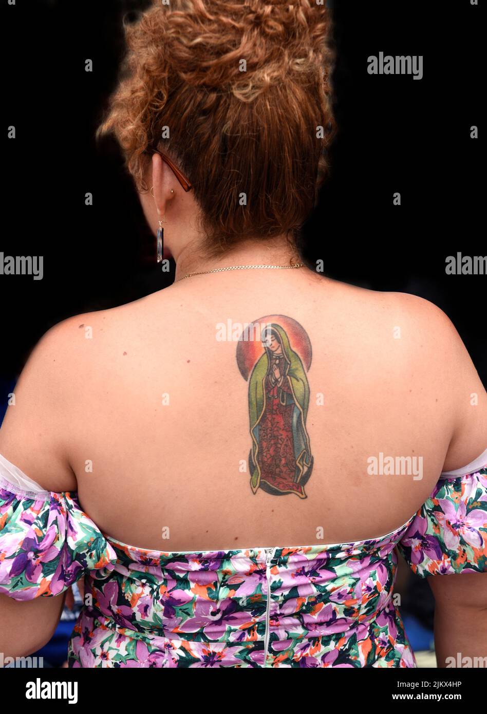 A woman with a tattoo of Our Lady of Guadalupe on her back in Santa Fe, New Mexico. Stock Photo