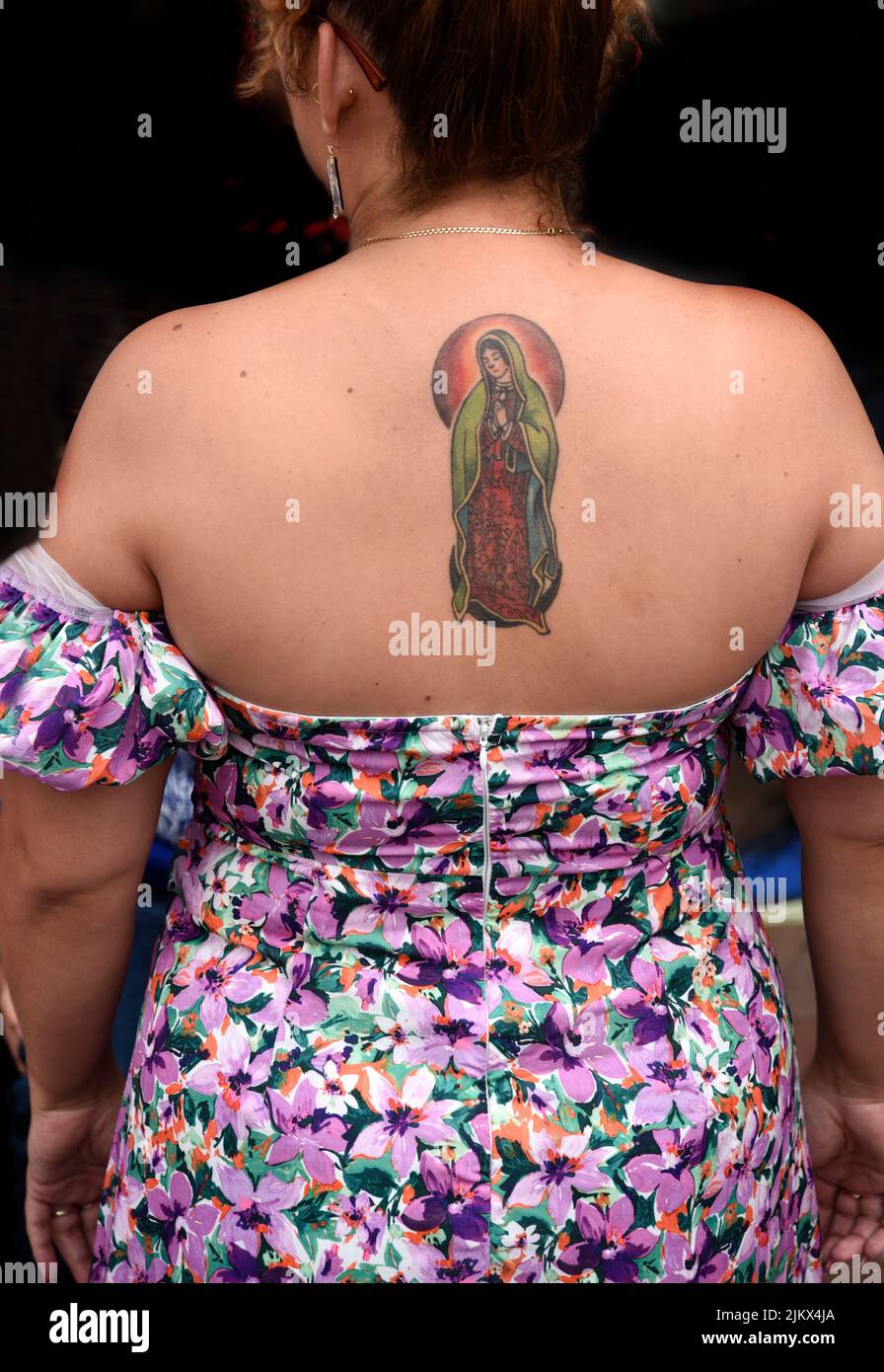 A woman with a tattoo of Our Lady of Guadalupe on her back in Santa Fe, New Mexico. Stock Photo